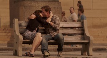Movie still from “Baby Mama” (2008), directed by Michael McCullers – A man and a woman kissing on a bench; Wide shot, Over the shoulder angle