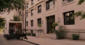 Movie still from “Baby Mama” (2008), directed by Michael McCullers – A man walking down the sidewalk in front of an apartment building; Extreme Wide shot, High angle