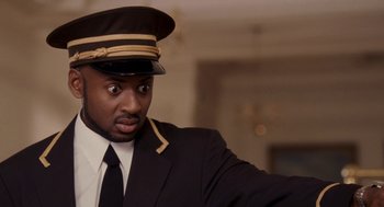 Movie still from “Baby Mama” (2008), directed by Michael McCullers – A man wearing a uniform and a hat is taking a selfie; Close Up shot, Low angle