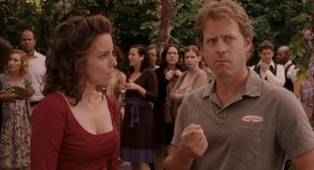 Movie still from “Baby Mama” (2008), directed by Michael McCullers – A man and a woman standing next to each other in front of a group of people; Medium shot, Over the shoulder angle