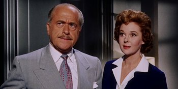 Movie still from “Back Street” (1961), directed by David Miller – An older man and a younger woman standing next to each other; Close Up shot, Low angle