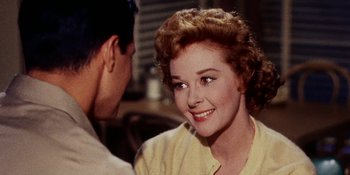 Movie still from “Back Street” (1961), directed by David Miller – An older woman smiles at a young man in front of a window; Close Up shot, Over the shoulder angle