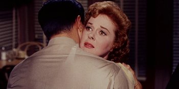 Movie still from “Back Street” (1961), directed by David Miller – A woman is hugging a man while they both look at each other; Close Up shot, Over the shoulder angle