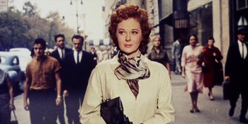 Movie still from “Back Street” (1961), directed by David Miller – A woman in a white shirt and a zebra print neck scarf; Close Up shot, Low angle