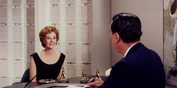 Movie still from “Back Street” (1961), directed by David Miller – An older man and woman sitting in front of a mirror; Medium shot, Over the shoulder angle