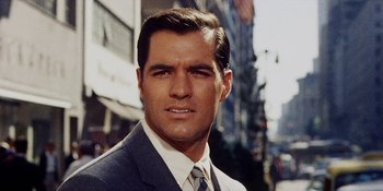 Movie still from “Back Street” (1961), directed by David Miller – A person wearing a suit and tie; Close Up shot, Low angle