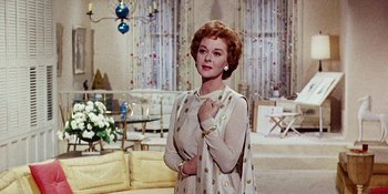 Movie still from “Back Street” (1961), directed by David Miller – An older woman standing in front of a living room; Medium shot, Low angle