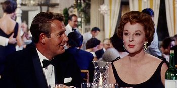 Movie still from “Back Street” (1961), directed by David Miller – A man and a woman sitting at a dinner table; Close Up shot, Over the shoulder angle