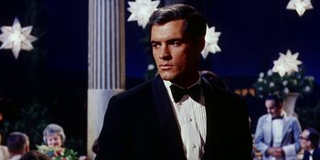 Movie still from “Back Street” (1961), directed by David Miller – A man in a suit and bow tie; Close Up shot, Low angle