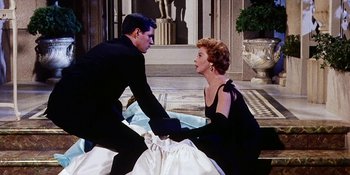 Movie still from “Back Street” (1961), directed by David Miller – A man and a woman sitting on the ground; Medium shot, Low angle