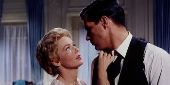 Movie still from “Back Street” (1961), directed by David Miller – A man and a woman looking at one another; Close Up shot, Low angle