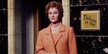 Movie still from “Back Street” (1961), directed by David Miller – An older woman wearing a suit and pearl necklace; Medium shot, Low angle