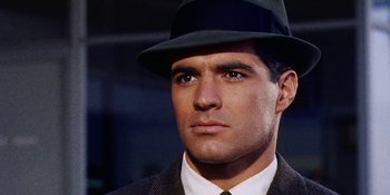Movie still from “Back Street” (1961), directed by David Miller – A person wearing a suit and a hat; Close Up shot, Low angle