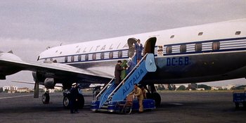 Movie still from “Back Street” (1961), directed by David Miller – People are boarding an airplane on a runway; Wide shot, Low angle