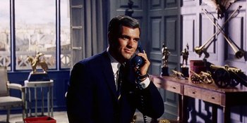 Movie still from “Back Street” (1961), directed by David Miller – A man talking on a phone while wearing a suit and tie; Close Up shot, Low angle