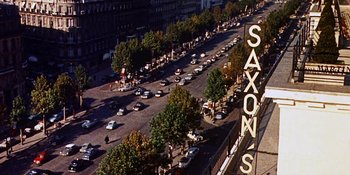 Movie still from “Back Street” (1961), directed by David Miller – An aerial view of a busy city street with cars driving down the road; Extreme Wide shot, High angle