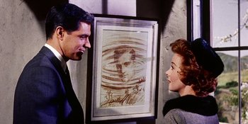 Movie still from “Back Street” (1961), directed by David Miller – A man and a woman are looking at a picture; Medium shot, Over the shoulder angle