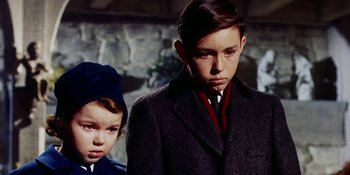 Movie still from “Back Street” (1961), directed by David Miller – A young boy and a young girl standing next to each other; Close Up shot, Low angle