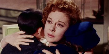 Movie still from “Back Street” (1961), directed by David Miller – An old woman crying while hugging a young man; Close Up shot, Over the shoulder angle