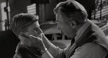 Movie still from “Back to School” (1986), directed by Alan Metter – An older man touching a younger man's face; Close Up shot, Over the shoulder angle