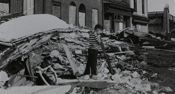 Movie still from “Back to School” (1986), directed by Alan Metter – A little boy standing in the middle of a pile of rubble; Wide shot, Low angle