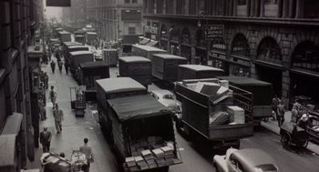 Movie still from “Back to School” (1986), directed by Alan Metter – A black and white photo of a busy city street; Extreme Wide shot, High angle