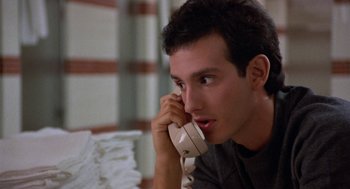 Movie still from “Back to School” (1986), directed by Alan Metter – A man holding a phone up to his ear; Close Up shot, Low angle