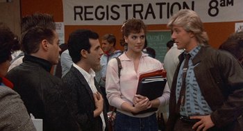 Movie still from “Back to School” (1986), directed by Alan Metter – A group of people standing next to each other in a room; Medium shot, Over the shoulder angle