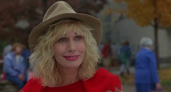 Movie still from “Back to School” (1986), directed by Alan Metter – A woman wearing a hat and a red shirt; Close Up shot, Low angle