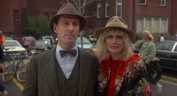 Movie still from “Back to School” (1986), directed by Alan Metter – A man and a woman wearing hats posing for a picture; Close Up shot, Low angle