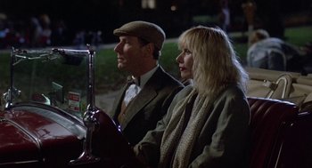 Movie still from “Back to School” (1986), directed by Alan Metter – A man and a woman sitting next to each other; Medium shot, Over the shoulder angle