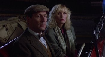 Movie still from “Back to School” (1986), directed by Alan Metter – A man and a woman sitting next to each other; Close Up shot, Over the shoulder angle