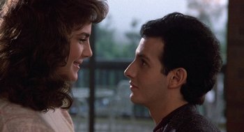 Movie still from “Back to School” (1986), directed by Alan Metter – A man and a woman looking at each other; Close Up shot, Over the shoulder angle