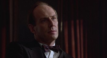 Movie still from “Back to School” (1986), directed by Alan Metter – A man in a suit and a bow tie; Close Up shot, Low angle