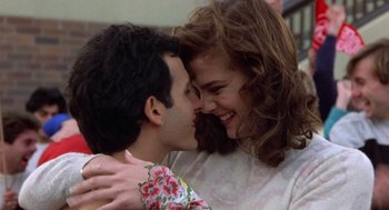 Movie still from “Back to School” (1986), directed by Alan Metter – A man and a woman are smiling at each other; Close Up shot, Low angle