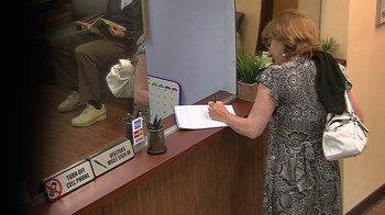 Movie still from “Jackass Presents: Bad Grandpa” (2013), directed by Jeff Tremaine – A woman writing on a piece of paper in front of a mirror; Medium shot, High angle