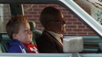 An older man and a young boy in a car