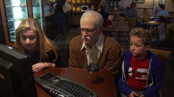 Movie still from “Jackass Presents: Bad Grandpa” (2013), directed by Jeff Tremaine – An older man sitting at a table with two young children; Medium shot, Over the shoulder angle