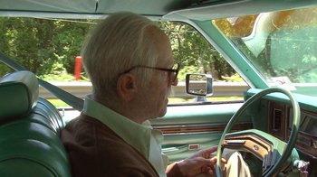 Movie still from “Jackass Presents: Bad Grandpa” (2013), directed by Jeff Tremaine – An older man sitting in the driver's seat of a car; Close Up shot, Over the shoulder angle