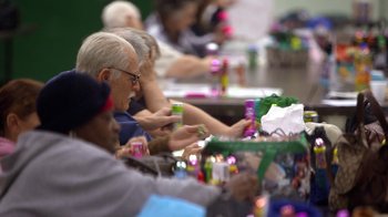 Movie still from “Jackass Presents: Bad Grandpa” (2013), directed by Jeff Tremaine – A group of people sitting at a table with drinks; Medium shot, High angle