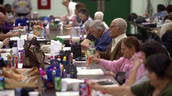 Movie still from “Jackass Presents: Bad Grandpa” (2013), directed by Jeff Tremaine – A group of people sitting at a long table with drinks; Medium shot, High angle
