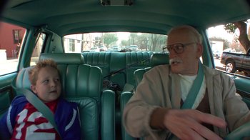 Movie still from “Jackass Presents: Bad Grandpa” (2013), directed by Jeff Tremaine – An older man and a young boy in a car; Medium shot, Over the shoulder angle