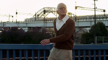 Movie still from “Jackass Presents: Bad Grandpa” (2013), directed by Jeff Tremaine – An older man wearing a brown sweater and beige pants; Medium shot, Low angle