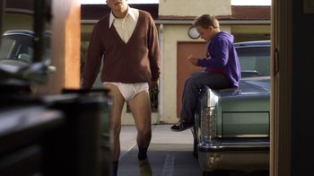 Movie still from “Jackass Presents: Bad Grandpa” (2013), directed by Jeff Tremaine – A man wearing a diaper walking down the street; Wide shot, Low angle