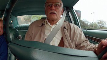 Movie still from “Jackass Presents: Bad Grandpa” (2013), directed by Jeff Tremaine – An older man sitting in the passenger seat of a car; Close Up shot, Low angle