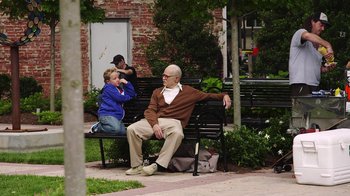 Movie still from “Jackass Presents: Bad Grandpa” (2013), directed by Jeff Tremaine – An older man sitting on a park bench with a young boy sitting next to him; Wide shot, Over the shoulder angle