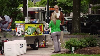 Movie still from “Jackass Presents: Bad Grandpa” (2013), directed by Jeff Tremaine – A man and a woman standing in front of a food truck; Wide shot, Over the shoulder angle