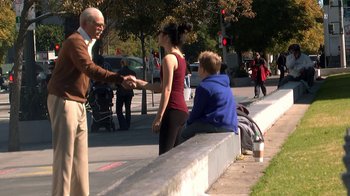 Movie still from “Jackass Presents: Bad Grandpa” (2013), directed by Jeff Tremaine – A man and a woman talking to a woman sitting on a bench; Wide shot, Over the shoulder angle