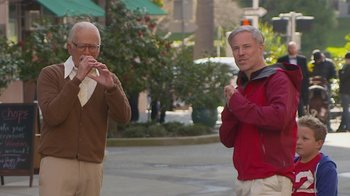Movie still from “Jackass Presents: Bad Grandpa” (2013), directed by Jeff Tremaine – Two older men standing next to each other on the street; Medium shot, Over the shoulder angle