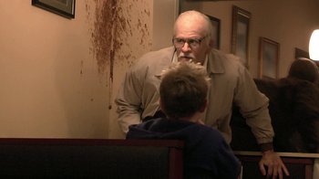 Movie still from “Jackass Presents: Bad Grandpa” (2013), directed by Jeff Tremaine – An older man and a young boy in a room; Medium shot, Over the shoulder angle